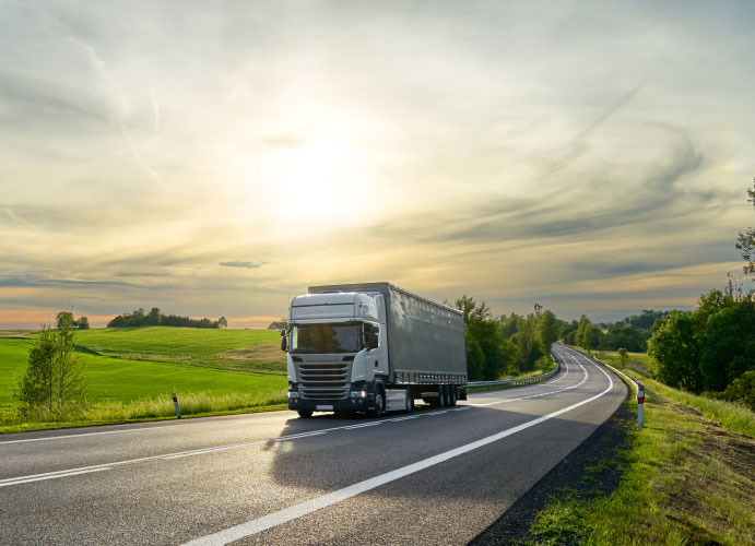 Truck travelling through countryside carrying recycled materials